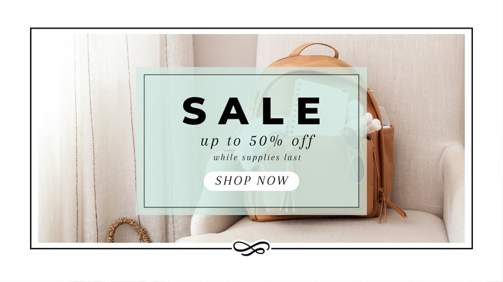 A stylish promotional banner announcing a 'SALE up to 50% off' on products. The image features a modern interior scene with a beige backpack and baby items peeking out, placed on a chic sofa next to a beige curtain. The backdrop is soft and neutral, emphasizing the clean, elegant design of the ad. A bold 'SHOP NOW' button invites viewers to take advantage of the limited-time offer.