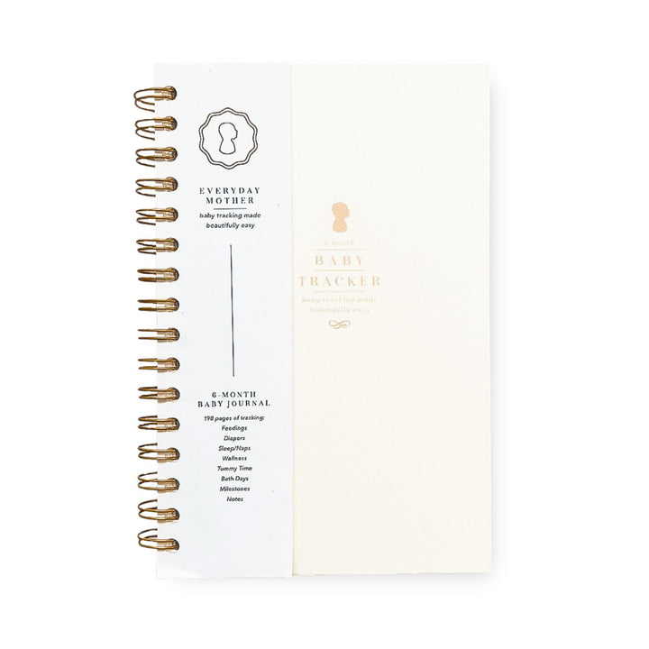 Elegant Daily Baby Tracker book from The Everyday Mother with gold spiral binding and minimalist design, ready to keep track of your little one's daily milestones and memories.