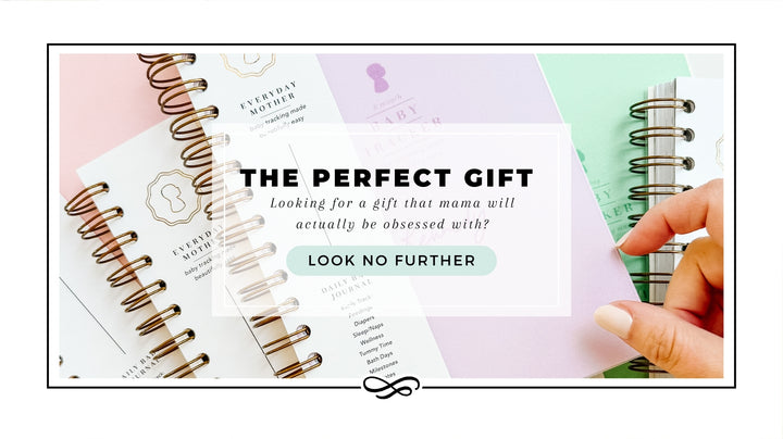 Promotional image for The Everyday Mother journal, ideal for gifting, displaying multiple pages of the journal spread out, featuring neat, spiral-bound designs. The left page is pink and the right page is green, each adorned with elegant, gold designs. A hand is seen pointing to one of the pages. Bold text overlays the image proclaiming 'THE PERFECT GIFT' and encouraging viewers to 'LOOK NO FURTHER' for a gift that a mom will adore.